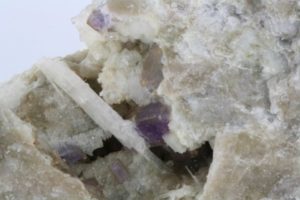 white crystals of purple fluorite and bikitaite from North Carolina, United States