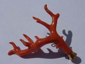 coral branch mounted as breastpin