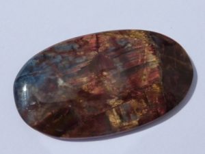 cabochon of yellow, red and blue pietersite from China