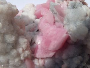 pink rhodochrosite on calcite crystal from Perou