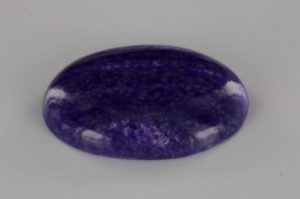 African sugilite cut in cabochon